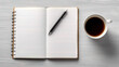 © swillklitch - Cup of coffee and notepad with pen, top view.