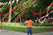 Child playing  with coloful tapes in the park outdoors