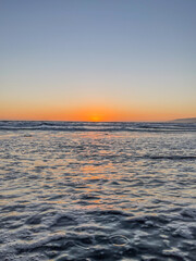 Wall Mural - sunset over the water with light rays reflected into the Pacific Ocean