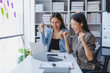 © amnaj - Two Asian businesswoman is excited and delighted achieved goal with laptop computer at office.