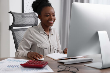 Sticker - Professional accountant working on computer at wooden desk in office