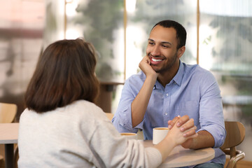 Wall Mural - Romantic date. Happy couple spending time together in cafe