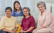 © Ann Rodchua - Portrait three senior Asian aging female sitting on sofa in cozy nursing home, smiling with happiness and healthy, looking at camera. Retirement, Healthcare, Aging Society Concept.