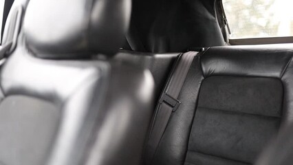 Wall Mural - black leather upholstery in the interior of a luxury car, business class seams.