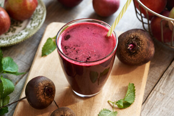 Wall Mural - Red beet juice in a glass, with fresh apples, beetroot and melissa