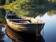 Small wooden rowboat tied to a rustic dock surrounded by still waters of a serene lake. 