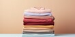 © AkimD - AI Generated. AI Generative. Fresh new washed laundy stack set of many cloth items on table. Graphic Art