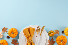 Form A Thanksgiving Table That Makes An Impression. Top View Photo Of Plates, Cutlery, Pumpkins, Anise, Napkin, Fallen Leaves On Light Blue Background With Promo Space