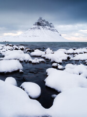 Canvas Print - Kirkjufell mountain, Iceland. Winter landscape. The mountain and the ocean. Snow and ice. A popular place to travel in Iceland.