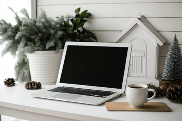 blank laptop screen on white wood table. christmas-themed living room. home office desk. copyspace m