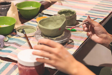 Pottery lesson master class for kids children, process of making clay pot on pottery wheel, potter hands creating ceramic crockery handcrafts, ceramist molding and painting jar or vase