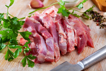 Wall Mural - Fresh turkey thigh chops on wooden background with parsley and garlic