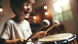 Close-up image in a music studio with soft indoor lighting. A child of a particular descent gleefully plays a drum with mallets
