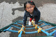 © Arlette - 4 year old Latina brunette girl with eye glasses plays in the playground as therapy for Attention Deficit Hyperactivity Disorder ADHD
