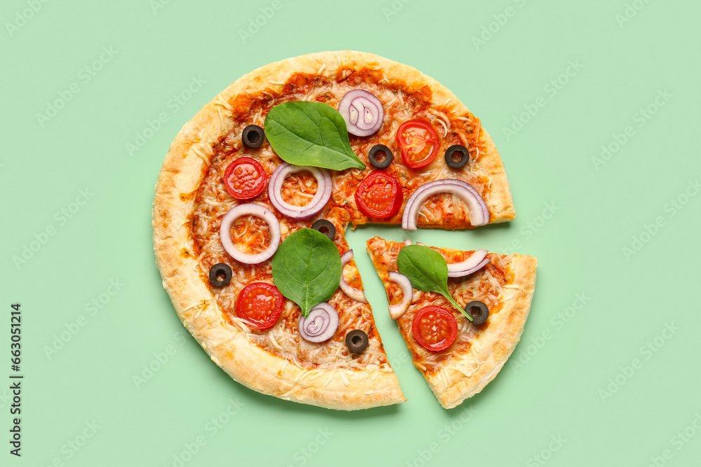 Tasty pizza with basil and tomatoes on green background