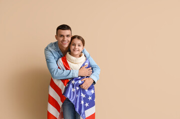 Wall Mural - Young man and his little daughter with USA flag on beige background. Veterans Day celebration