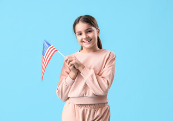 little girl with usa flag on blue background. veterans day celebration