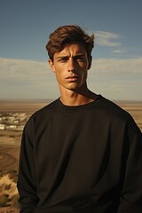 Wall Mural - Portrait of a handsome young man in a black sweatshirt.