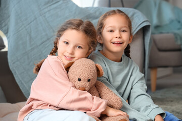 Poster - Cute little girls with toy bear at home