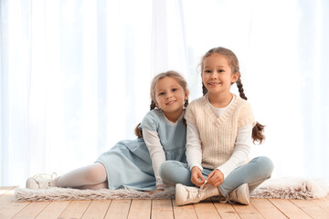 Poster - Cute little girls sitting at home