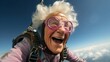 © mariiaplo - With a smile in the sky, senior lady proves age can't stop the fun of skydiving.