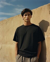 Wall Mural - Portrait of a handsome young man wearing black t-shirt and shorts. Men's beauty, fashion.