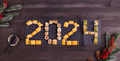 2024 Happy new year greeting banner. Assorted set of various sushi rolls with tuna, salmon, eel, avocado, vegetables. The sushi rolls are laid out in numbers 2024. 