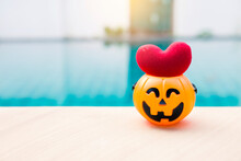 Red Heart In Halloween Pumpkin On Swimming Pool Edge, Outdoor Day Light, Happy Halloween Background Idea
