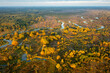 Aerial view of autumn nature on early morning. Aerial view on woods, meadows and winding river flowing between them. Belarus is a coutry of lakes and rivers.