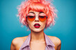 © JuanM - Young lo fi woman with vibrant pink curly hair wearing retro clothes