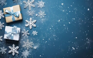 Christmas toned blue background with snowflakes, snow dust, two gifts. Top view, overhead, copy space on the right side