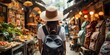 Woman traveler with backpack and hat sightseeing through the streets and street food stall markets in Asia.