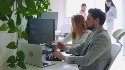 Male IT Programmer Thinking with Working on Computer. Guy Writing Code in Terminal.