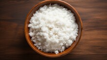 A Wooden Plate Filled With Fluffy White Rice Sits On A Table, Ready To Be Served