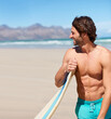 © Marine Gastineau/peopleimages.com - Surfing, fitness and happy man at a beach with surfboard for training, hobby or fun in nature. Water, sports and male surfer relax at the sea for travel, freedom and adventure workout in Hawaii