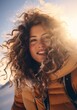 © Glittering Humanity - A snow-kissed sky frames a joyful woman, her ringlets bouncing in the wind as she smiles in her winter clothing, a portrait of wild beauty in the great outdoors