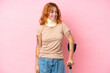 © luismolinero - Young caucasian woman wearing neck brace isolated on pink background looking to the side and smiling
