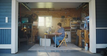 Fototapete - Caucasian Male Software Engineer Programming On Old Desktop Computer In Retro Garage With Random Appliances. Man Working On Innovative Online Service Startup Company In Nineties. Nostalgia Concept.
