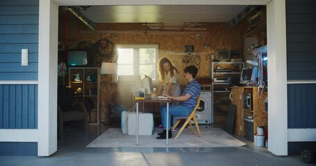 Fototapete - Caucasian Male Software Developer And Hispanic Female Designer Talking And Using Old Desktop Computer in Retro Garage. Diverse Startup Founders Working On Online Service In Nineties. Nostalgia Concept