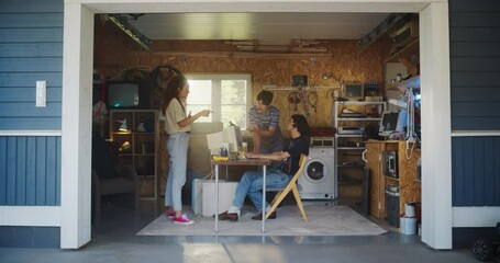 Fototapete - Diverse Team Of Three Young Startup Company Founders Working In Retro Garage, Using Old Desktop Computer. Male And Female Entrepreneurs Developing Innovative Online Service In Nostalgic Nineties.