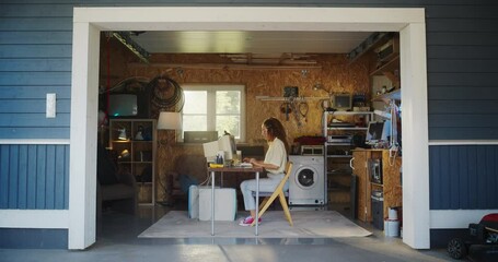 Fototapete - Hispanic Female Developer Programming On Old Desktop Computer In Retro Garage With Random Appliances. Young Woman Working On Innovative Online Service Startup Company In Nineties. Nostalgia Concept.