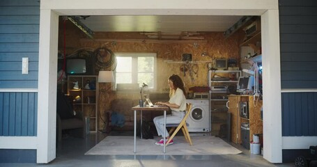 Fototapete - Hispanic Female Software Developer Programming On Laptop Computer In Garage At Home. Focused Young Woman Working On Innovative Online Service Startup Company, Coding. Digital Entrepreneur Concept.