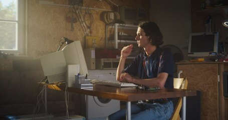 Poster - Caucasian Male Software Engineer Programming On Old Desktop Computer In Retro Garage With Random Appliances. Man Starting an Innovative Fintech Startup Company In Nineties. Nostalgia Concept.