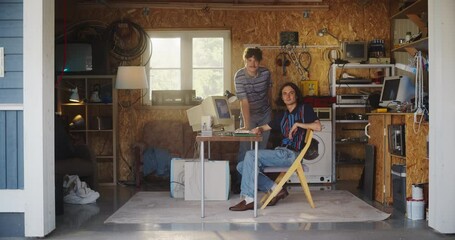 Aufkleber - Two Caucasian Male Tech Startup Founders Using Old Desktop Computer In Retro Garage, Looking At Camera And Smiling. Programmer And UX Designer Starting Internet Business In Nineties. Nostalgia Concept