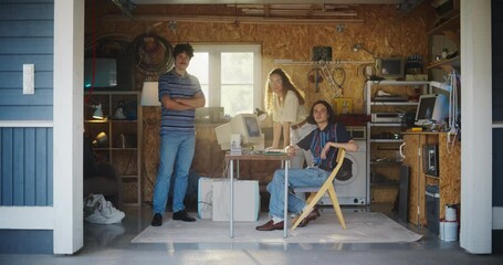 Fototapete - Diverse Team Of Three Young Startup Company Founders In Retro Garage With Old Desktop Computer. Male And Female Entrepreneurs Looking At Camera And Smiling, Developing Online Service In Nineties.