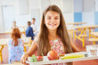 © Robert Kneschke - Happy schoolgirl with food tray in school cafeteria