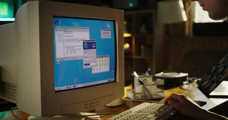 Poster - Zoom In Shot Of Caucasian Male College Student Using Old Desktop Computer In Nineties Retro Garage. Young Programmer Connecting World Wide Web Via Early Internet Software, Exploring Global Network.
