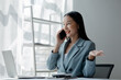 © pornpirose suparit - Businesswoman talking on the phone, business communication, telephone communication, Asian businesswoman working in a financial consulting service company, telephone consultation.