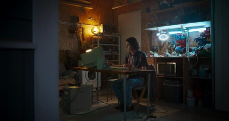 Fototapete - Wide Shot Of Caucasian Male Software Engineer Coding on Old Desktop Computer In Retro Garage In The Evening. Man Starting Tech Startup Company In Nineties. Coding Innovative Online Service At Home.