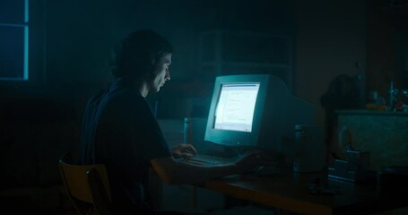 Leinwandbilder - Caucasian Male Web Designer Using Old Desktop Computer In Retro Garage Late At Night. Focused Internet Enthusiast Writing Code At Home. Programming Successful Online Forum Website In Nineties.